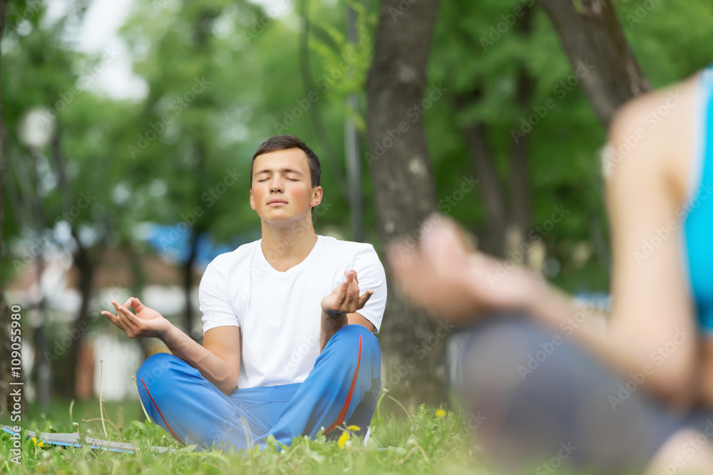 Fototapeta premium Having yoga practice in park