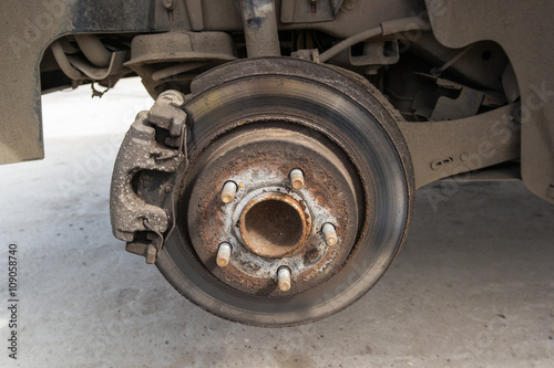Front disc brake on car in process of new tire replacement © Alexey Pelikh