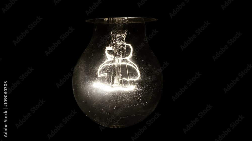 Glowing hanging light bulb dangle on a wire Glowing hanging light bulb dangle on a wire