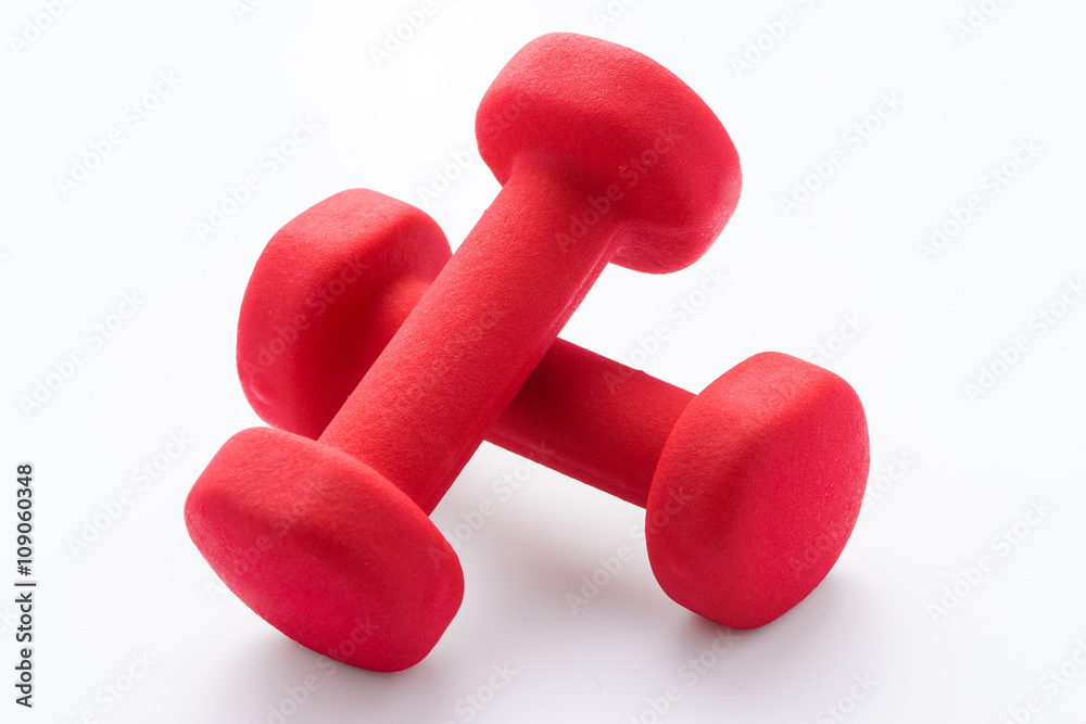 Pair of red rubber-coated dumbbells isolated on white background Pair of red rubber-coated dumbbells isolated on white background