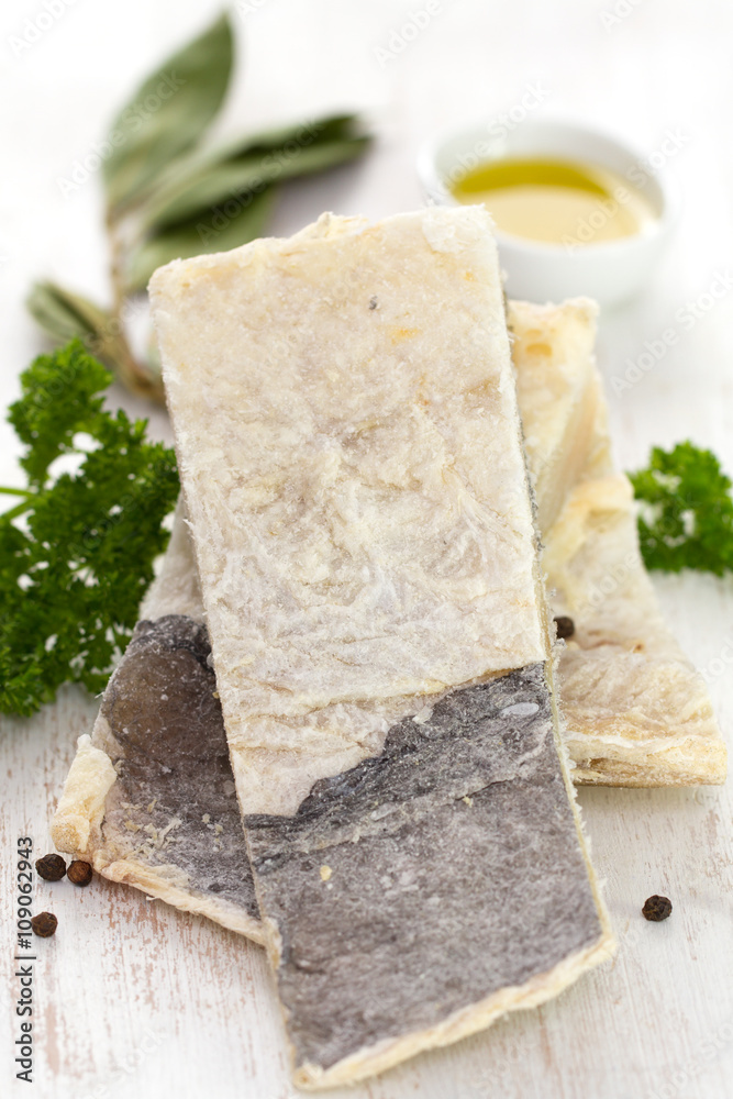 dry salted cod fish on white background