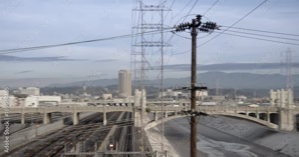 LOS ANGELES, CA, USA - DECEMBER 2015: Pan across the Los Angeles River to Downtown skyline, viewed across the Arts District, morning. Originally recorded in 4K DCI. LOS ANGELES, CA, USA - DECEMBER 2015: Pan across the Los Angeles River to Downtown skyline, viewed across the Arts District, morning. Originally recorded in 4K DCI.