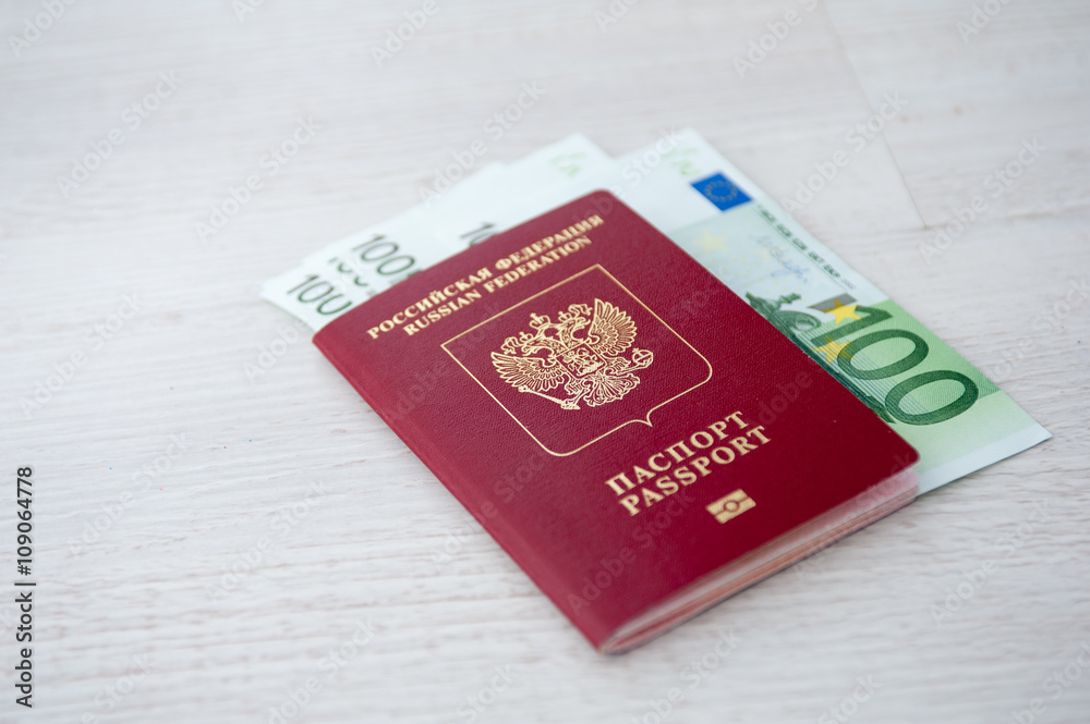Russian passport lies on a pile of euro banknotes Russian passport lies on a pile of euro banknotes