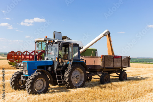 Harvest machine loading seeds in to trailer.