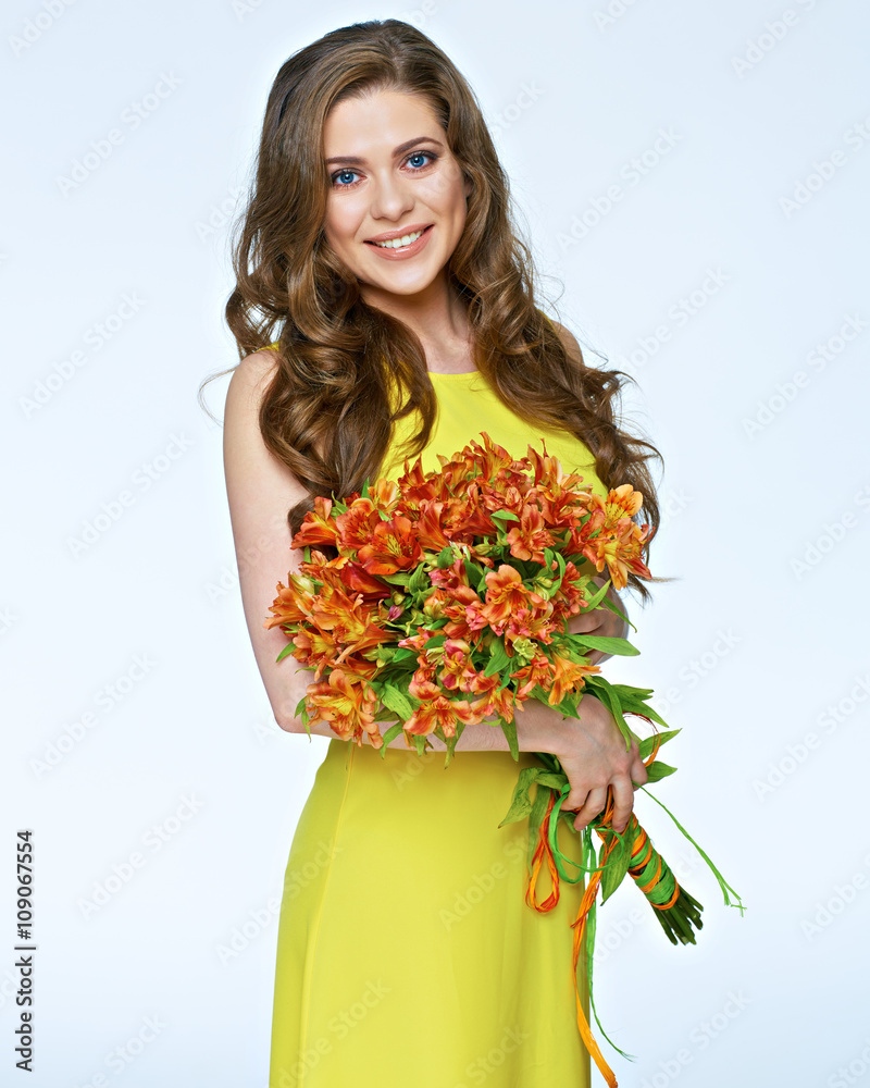 Smiling woman in yellow dress holding flowers bouquet. Smiling woman in yellow dress holding flowers bouquet.