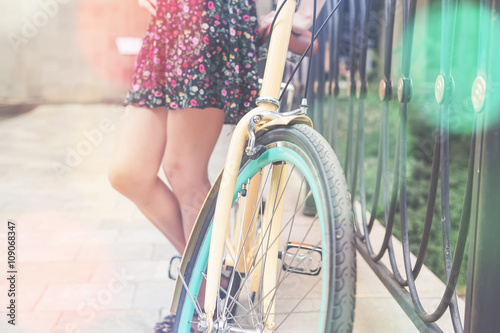 closeup of woman riding by blue vintage city bicycle