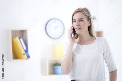 Portrait of beautiful blonde business woman talking on the phone