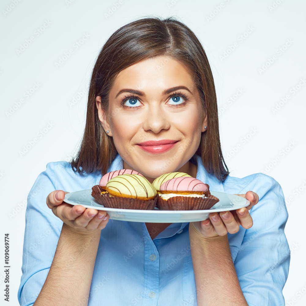 Woman holding plate with cookies and she wants to eat them. Woman holding plate with cookies and she wants to eat them.