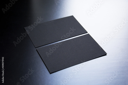 Blank business cards on a wooden background. Photo mock-up.
