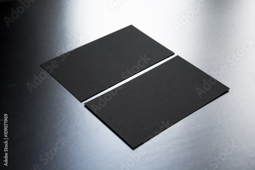 Blank business cards on a wooden background. Photo mock-up.