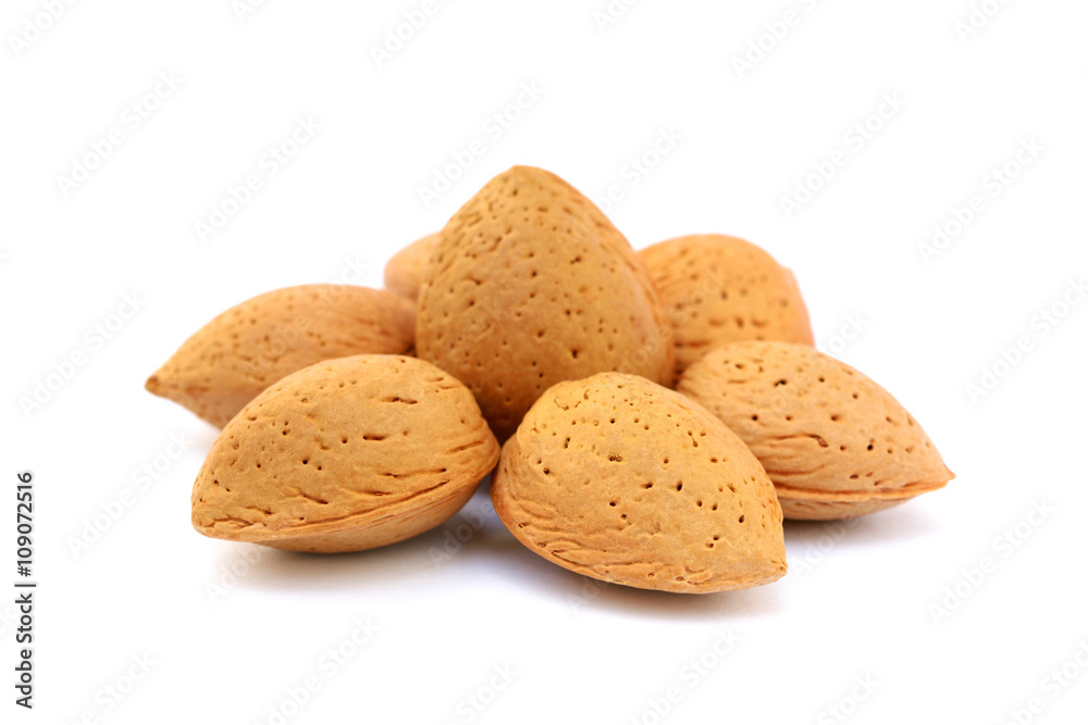 Heap of fresh almonds in shells isolated on white background Heap of fresh almonds in shells isolated on white background