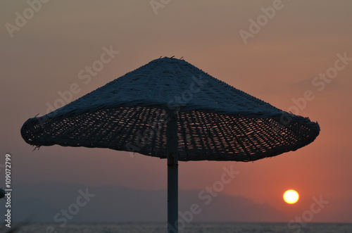 Reed parasol at sunset on the beach of the Mediterranean Sea  Kusadasi  Turkish Riviera  Turkey