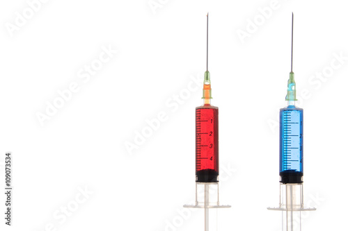 Two full syringes of different drugs photo