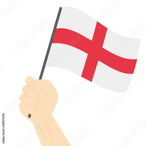 Hand holding and raising the national flag of England