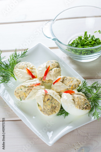 Dish with hard boiled eggs in mayonnaise parsley 