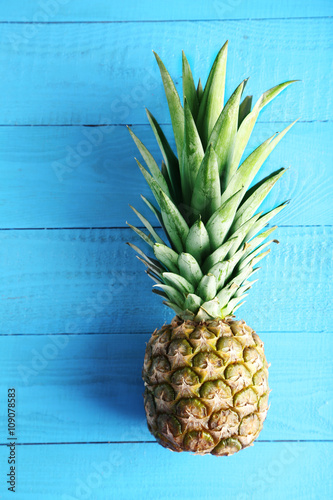 Ripe pineapple on a blue wooden table