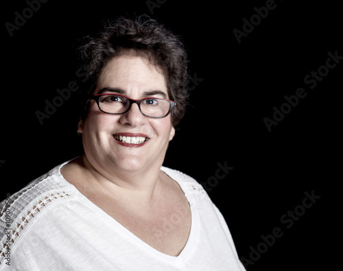 Quadro su tela Beautiful Heavy Set Middle-Aged Woman wearing Glasses in Studio