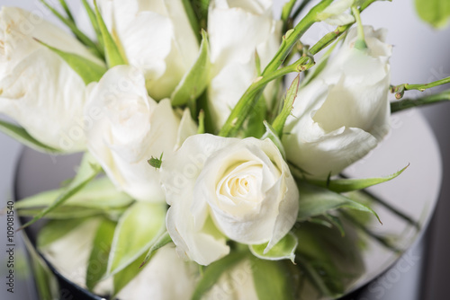 bouquet of white roses in a metal vase