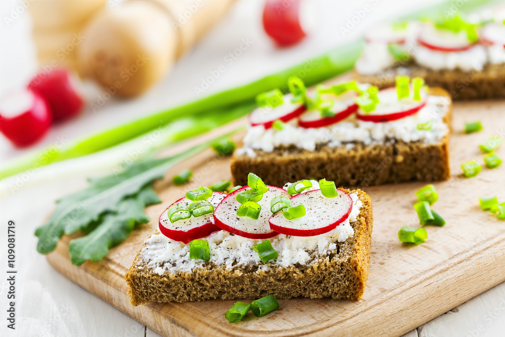 Delicious sandwiches with soft cream cheese and radish.  Vegetarian food.