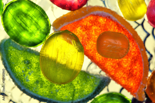 lollipops and slices of marmalade , top view. bright tropical background photo