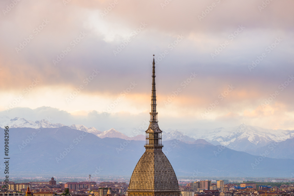 Cityscape of Torino (Turin, Italy) at sunset with storm clouds