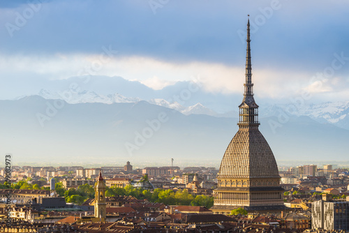 Cityscape of Torino (Turin, Italy) at sunset with storm clouds photo