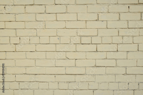 Yellow beige painted brick wall background