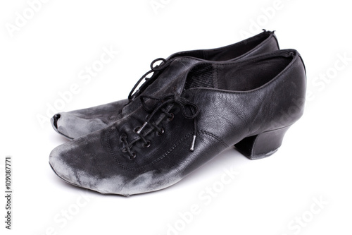 closeup shot of pair of worn-out latin ballroom dance shoes - isolated