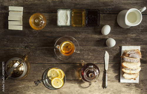 lemon tea and fruit candy on wooden table. © ugchannel