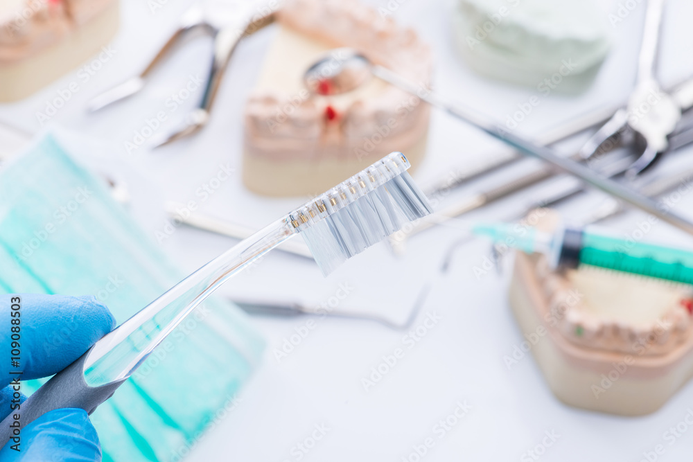 Teeth mold and basic dental tools on white table Teeth mold and basic dental tools on white table