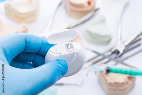 Teeth mold and basic dental tools on white table