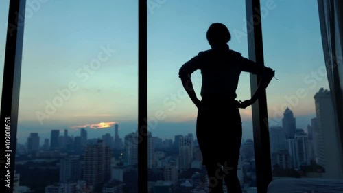 Young businesswoman admire cityscape at night, slow motion
