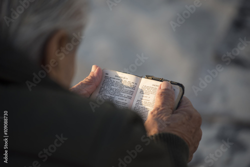 Old man reading holy bible book in spanish