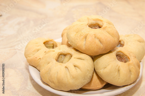 Bashkir national cuisine, homemade meat pies in white plate on a table photo