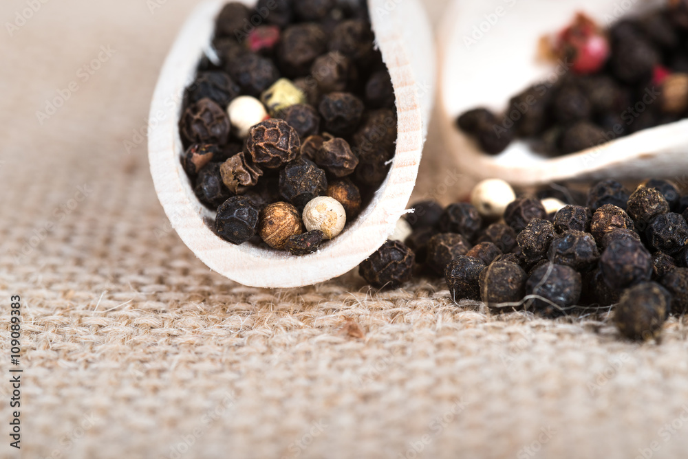 Wooden scoop with dried pepper berries Wooden scoop with dried pepper berries