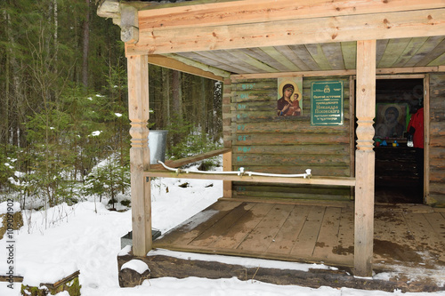 The wooden house above the spring of healing water photo