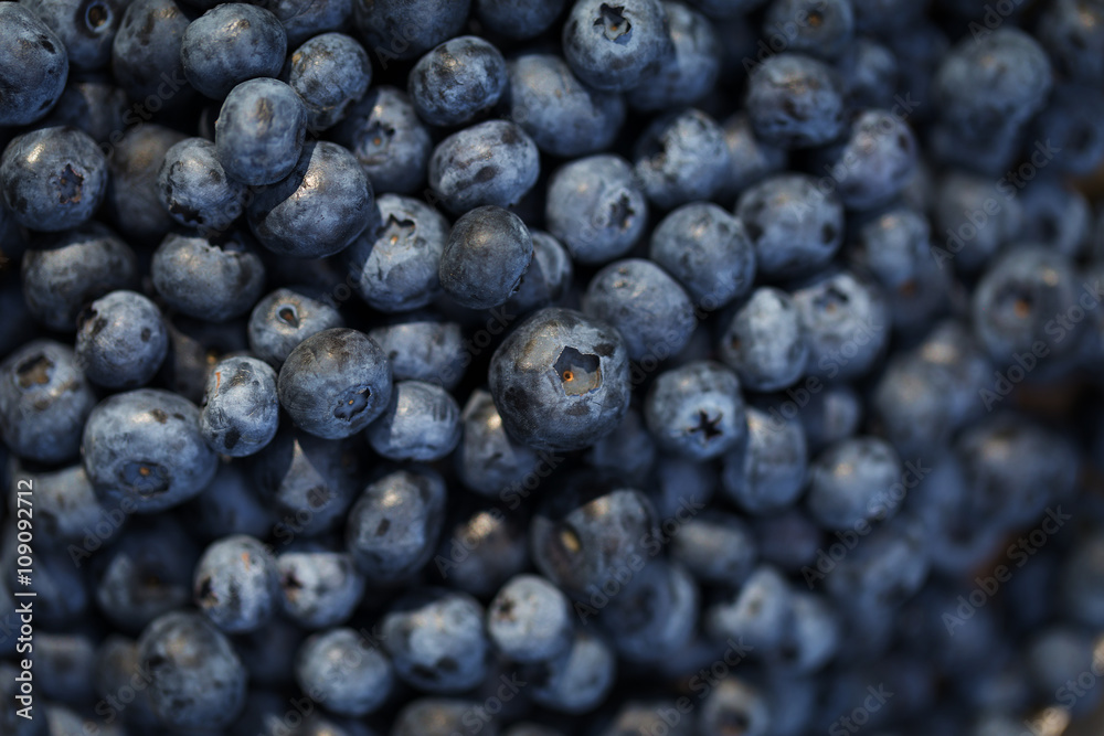 Fresh ripe blueberries outdoors on a wooden background Fresh ripe blueberries outdoors on a wooden background