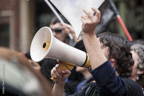 demostrator with megaphone and notebook protesting photo