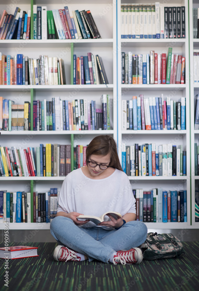 famale student reading book in library famale student reading book in library
