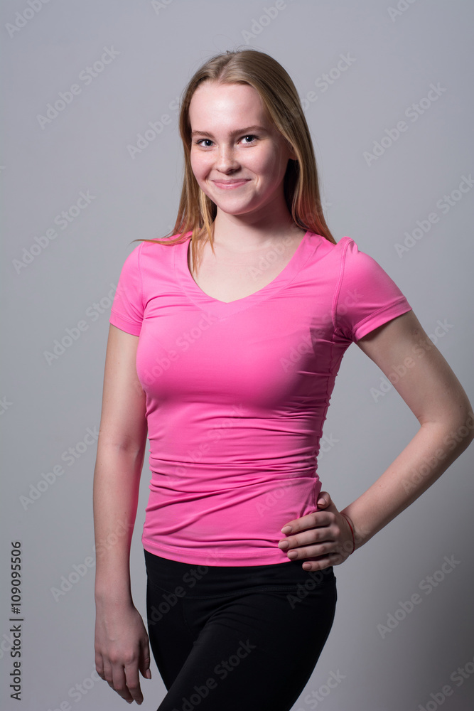 Portrait of a young athlete looking at the camera on a light background