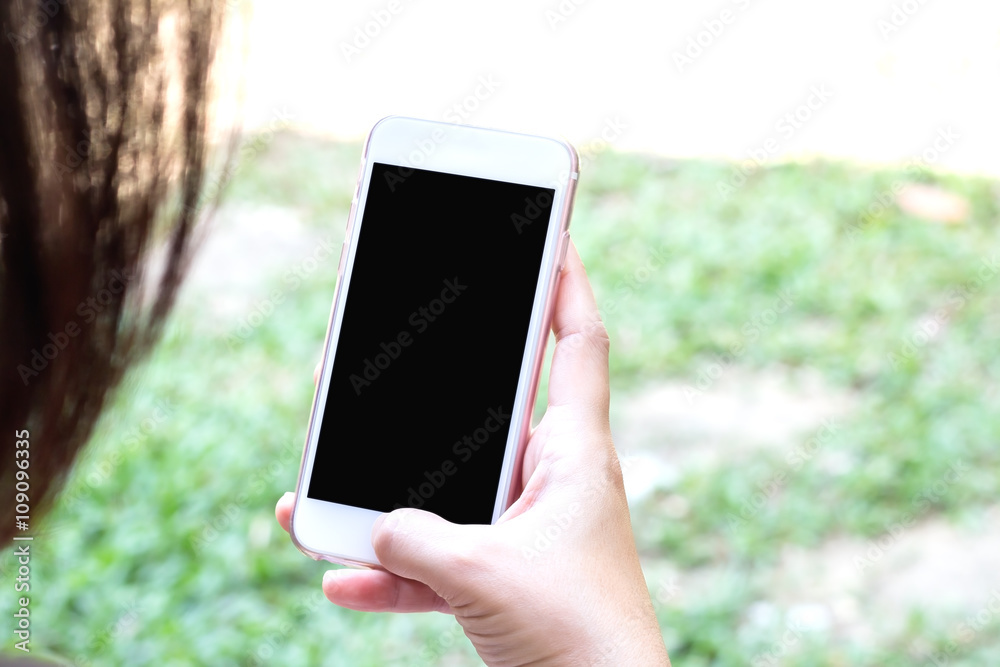 Closeup hand using smart  phone outdoor, clipping path inside