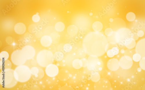 Gold glitter sparkles defocused rays lights bokeh abstract background.