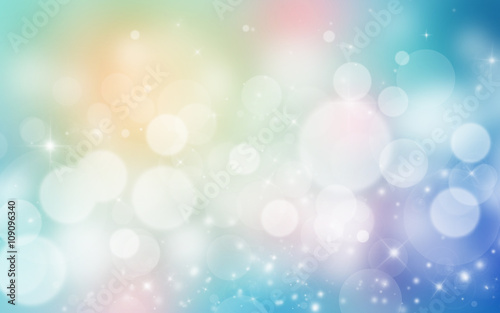Colorful glitter sparkles defocused rays lights bokeh abstract background.
