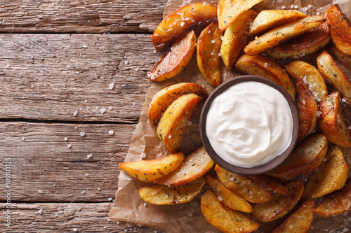 Fast food: Potato wedges and mayonnaise. horizontal top view 
