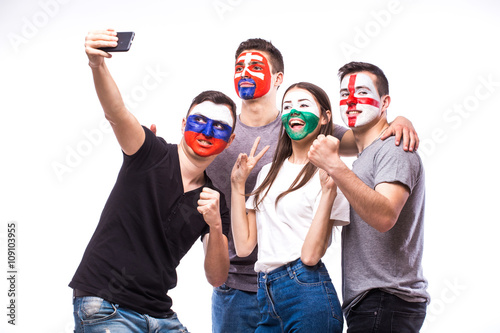 Group of football fans their national team: Slovakia, Wales, Russia, England take selfie photo on white background. European football fans concept.