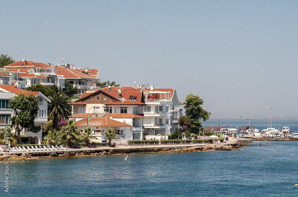 PRINCES ISLANDS, TURKEY - JULY 11, 2014 : View from the ferry, which runs along the route Istanbul - Buyukada. Architecture and tourists on the island Kinaliada