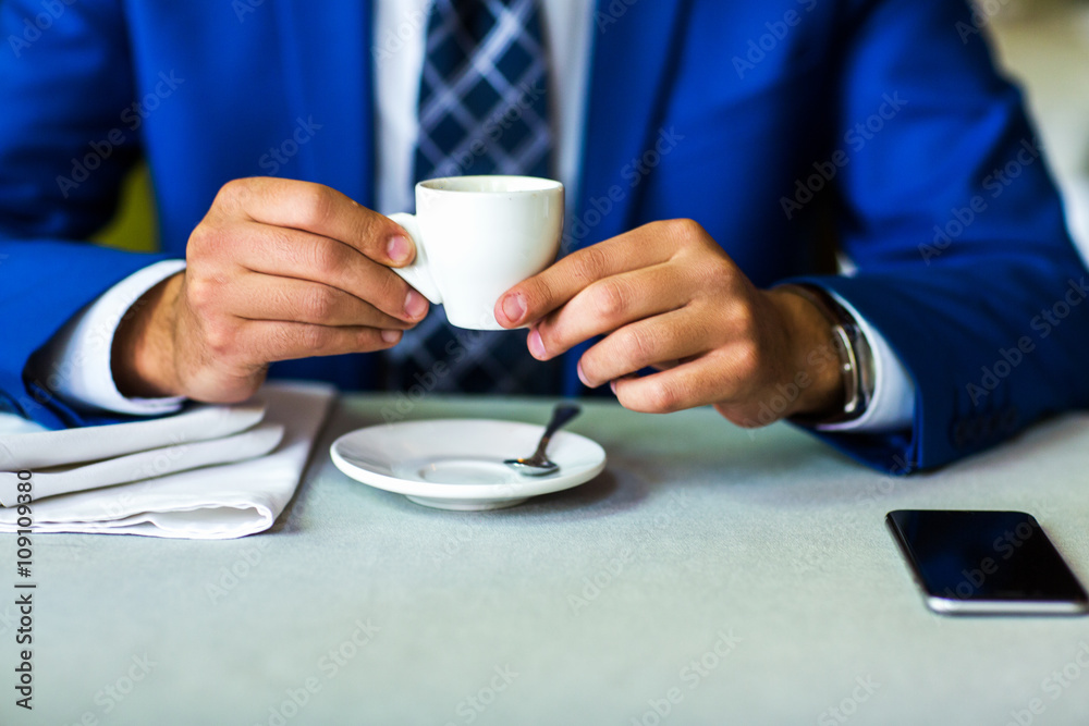 close-up of a cup of coffee in male hands