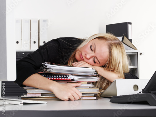 Overworked business woman at work has a headache photo