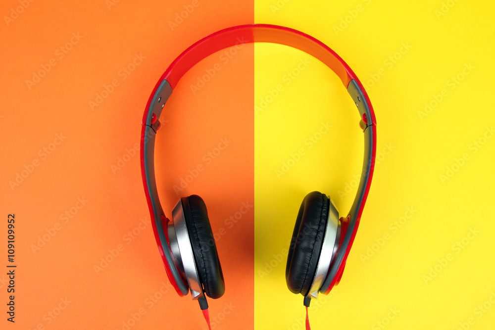 full-size wired headphones on a yellow and orange background