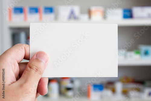 pharmacist holding blank paper in the pharmacy store